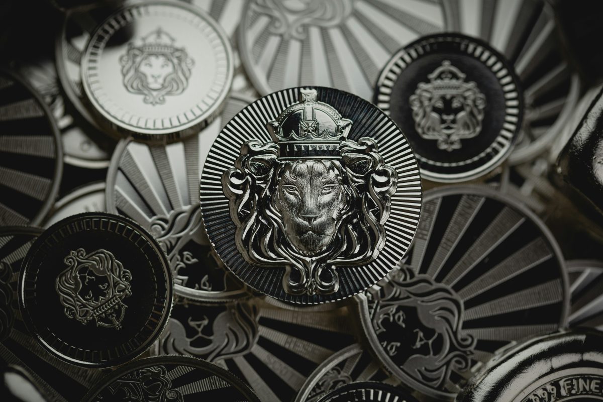 a close up of a coin with a lion head with crown 
