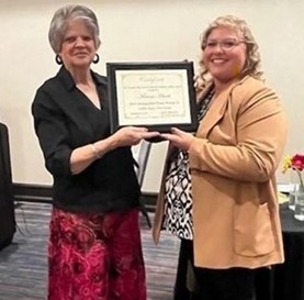 Pictured is Kay Brodbeck (left) presenting the national award to Marissa Adcock (right).