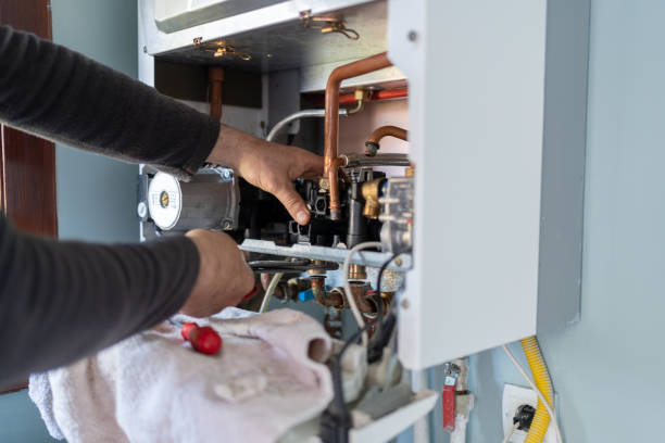 man working in a gas heating boiler at home