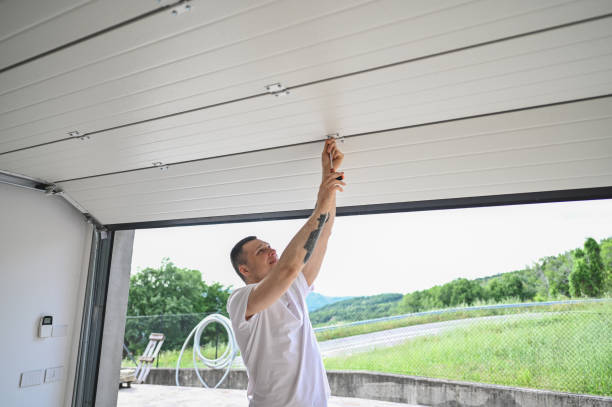 man repairing rolling garage door
