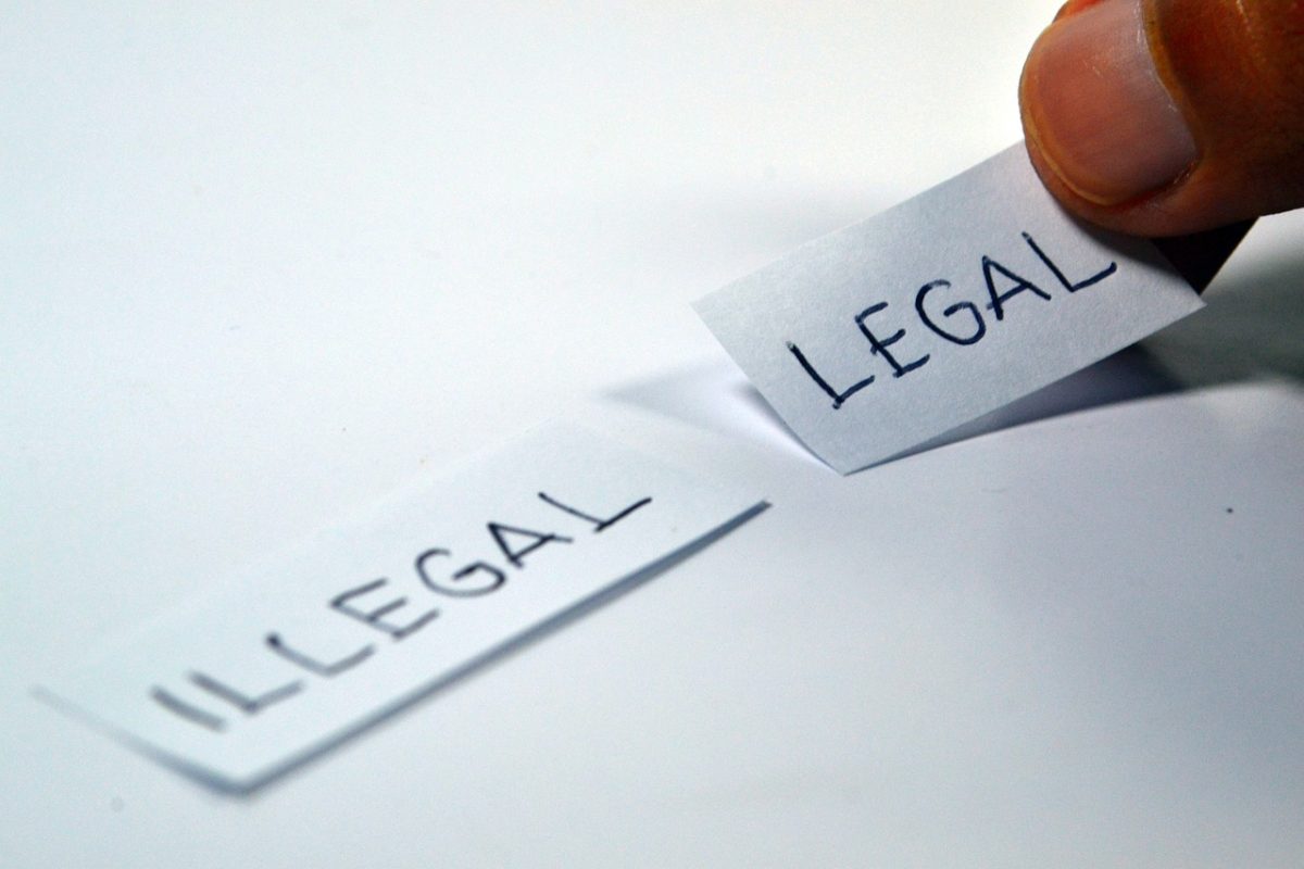 illegal and legal written on paper