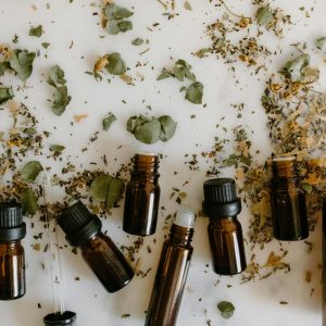 empty brown vials with crushed herbs surrounding