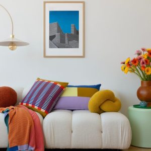 white couch with colorful pillows and vase