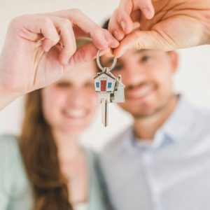 couple holding a key to their new home