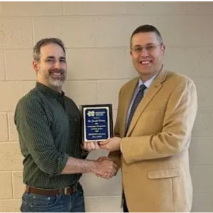 Dr. Joseph Kazery, left, MC instructor in biological sciences, receives Mississippi College's inaugural Outstanding Undergraduate Academic Advisor Award from MC Provost and Executive Vice President Mike Highfield.