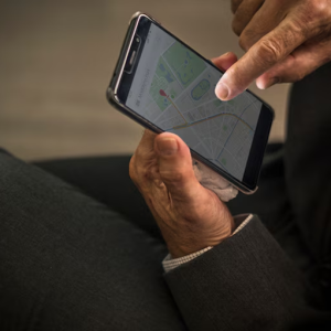man holding phone with maps