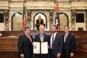 Mississippi Legislators presented Dr. Steven Reed with a Senate Resolution recognizing his election to lead the American Optometric Association. Pictured (l to r) are Senator Andy Berry; Steven Reed, OD; Senator David Parker, OD; and Senator Briggs Hopson. Lt. Gov. Hosemann stands in the background.