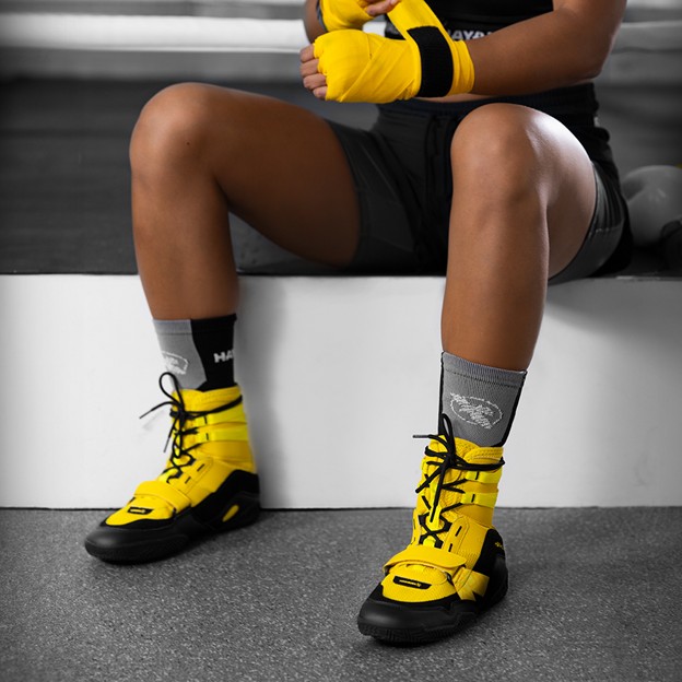 woman wearing yeallow Hayabusa Boxing Shoes and boxing gloves