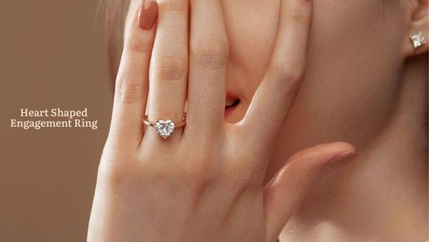 woman wearing heart shaped diamond engagement ring