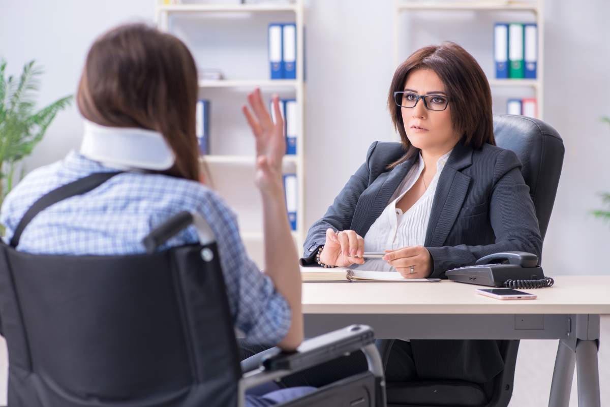 injured woman sits with attorney