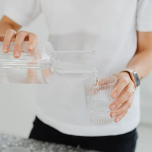 woman pouring a glass of clean water