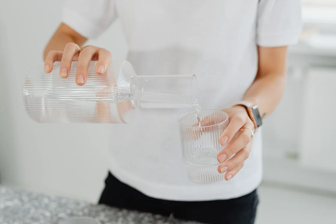 woman pouring a glass of clean water
