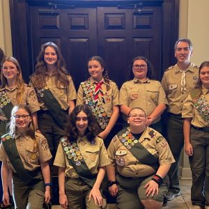 Preparing for a March 8 Scout Court of Honor are members of Troop 1475G (l to r), front row: Helen Dietrich, Avery Peacock and Brianna Smith; and back row: Assistant Scoutmaster Jenny Crawshaw, Anna Dietrich, Maria Dietrich, Lilly Grace Crawshaw, Abigail Johnson, Scoutmaster Daniel Watson and Linda Watson.