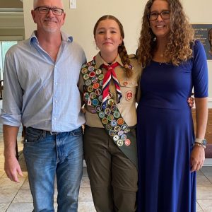 Lilly Grace Crawshaw is congratulated by her parents Brent and Jenny Crawshaw on her earning the Eagle Scout medal, the highest achievement in Scouting.