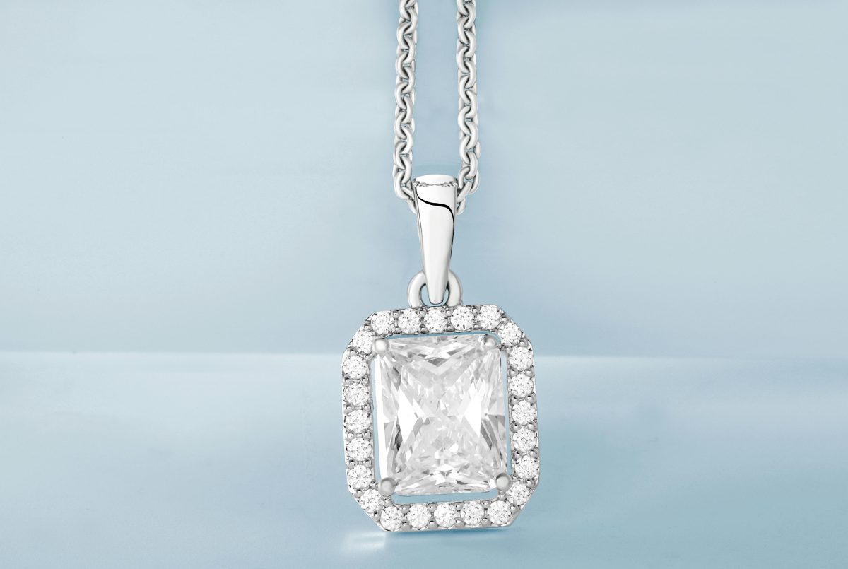 close up of diamond necklace with soft blue background