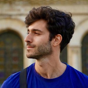 close up of man in blue shirt showing jawline