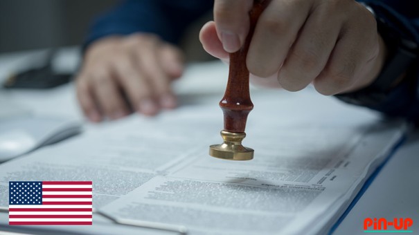 a hand holding a stamp over a paper