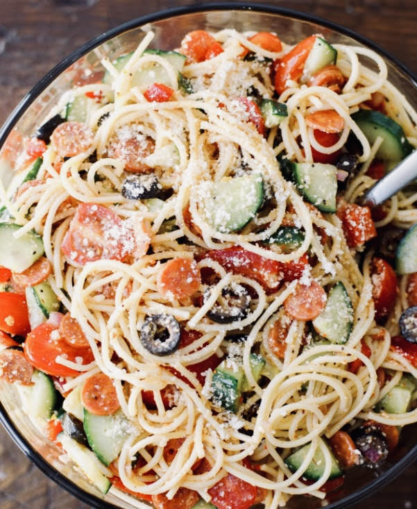 Spaghetti salad, full of chopped vegetables and tangy dressing, is the perfect hot-weather meal or side dish.