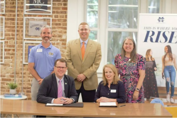 On hand to witness MC President Blake Thompson and Christ Covenant School Dean of Advisement Cheri Creel sign the MOU are, from left, Michael Wright, MC dean of enrollment services, Michael J. Highfield, MC provost and executive vice president, and Kristy Hawkins, CCS math teacher.