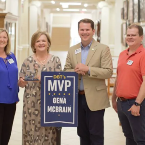 MC President Blake Thompson, second from right, presents the DBT's MVP Award for May to Gena McBrain, second from left, MC payroll administrator, while Ebby Dedeaux, MC controller, and Robert Turnage, the DBT's MVP for March, observe.