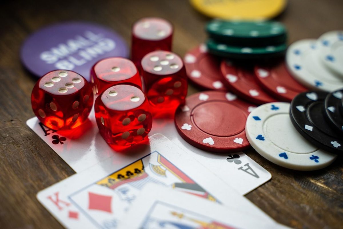 close up of casino chips, dice, and cards