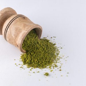 green powder with wooden cup