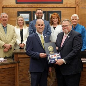 Fisher presented with proclamation, flag