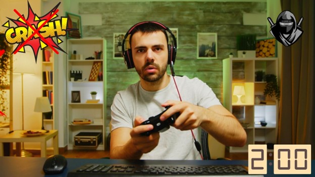 man wearing headphones while holding a controller and playing a computer game