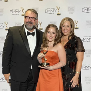 Flanked by her parents, Anthony and Amy Thaxton, Sydney Thaxton displays the 2025 Southeast EMMY Award she received for her work on the documentary film, "Eudora."
