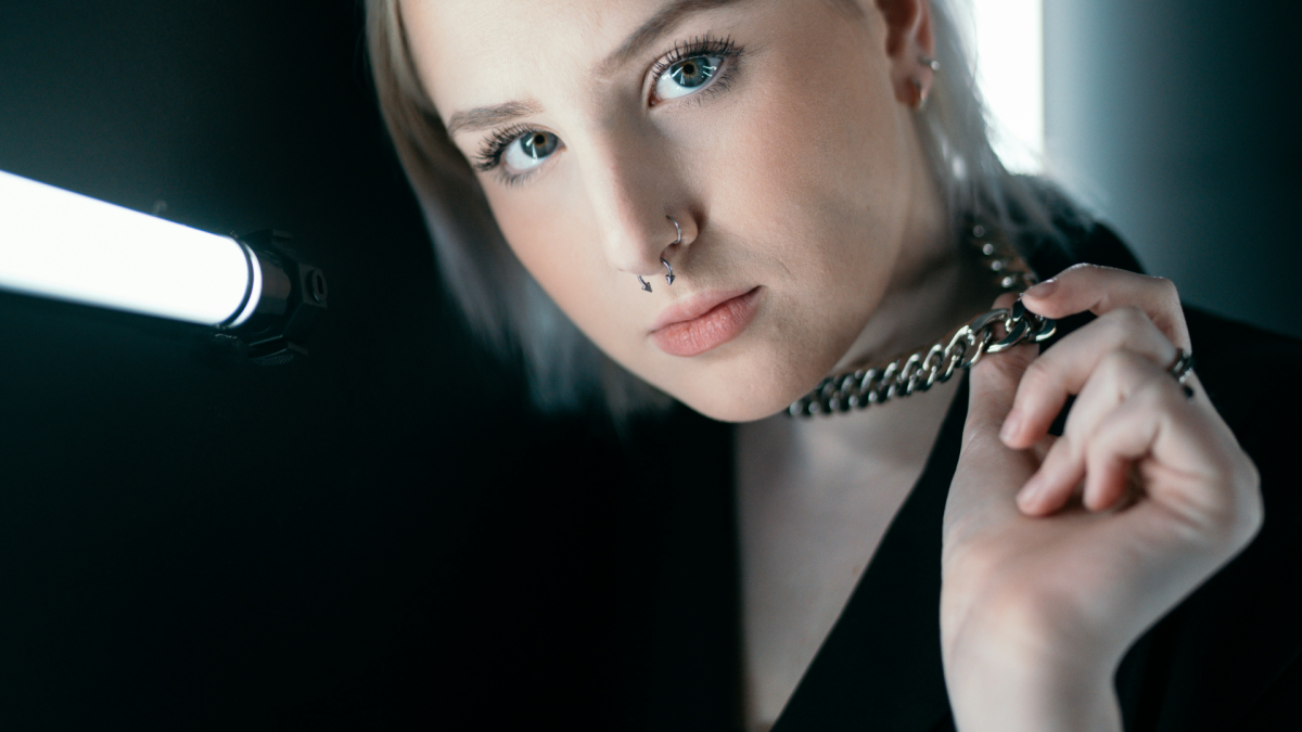 girl in black wearing s cuban chain link