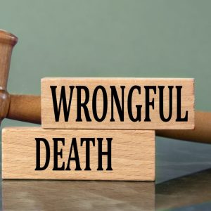 wrongful death written on blocks with a judge hammer on desk