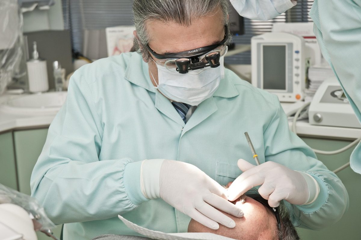male dentist looking in a patient's mouth