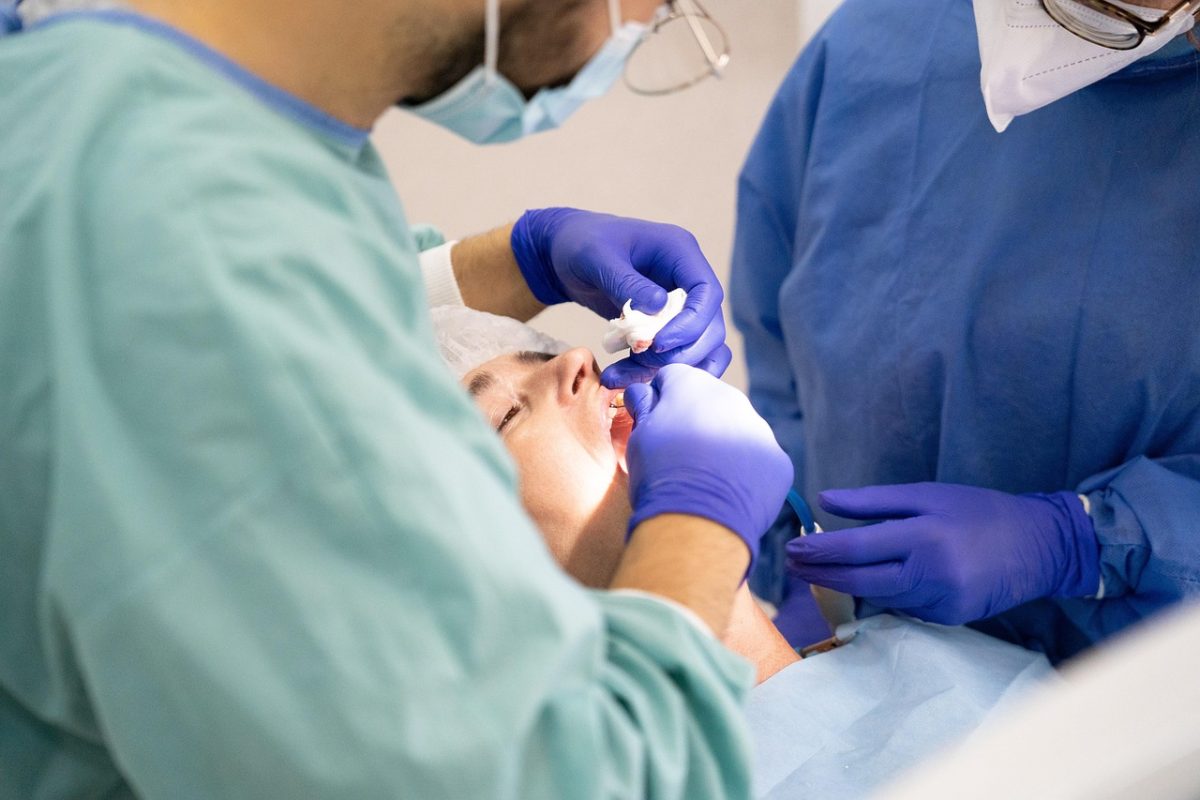 orthodontist looking in patient mouth