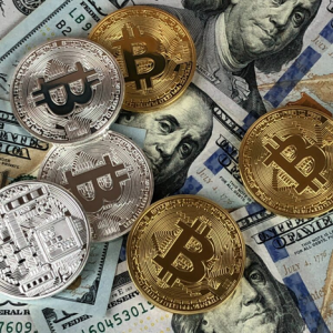 pile of coins with bitcoin and dollar bills