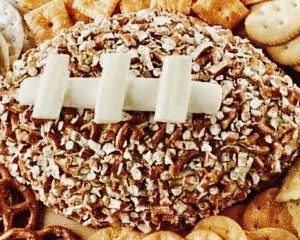 A football-shaped cheeseball filled with cream cheese and favorite additions is the perfect centerpiece for tailgating tables as well as watching the game at home.