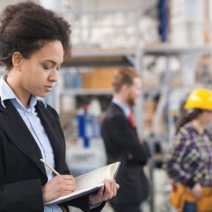 factory personel looking at notebook
