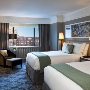 inside of a hotel room with 2 beds