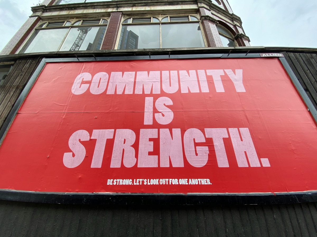 red and white community is strength sign