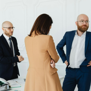 a group of legal professionals standing in front of a white wall