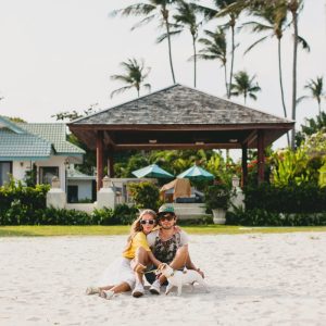 couple sitting in the sand at a beach