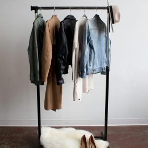 clothes on a clothing rack with white carpet