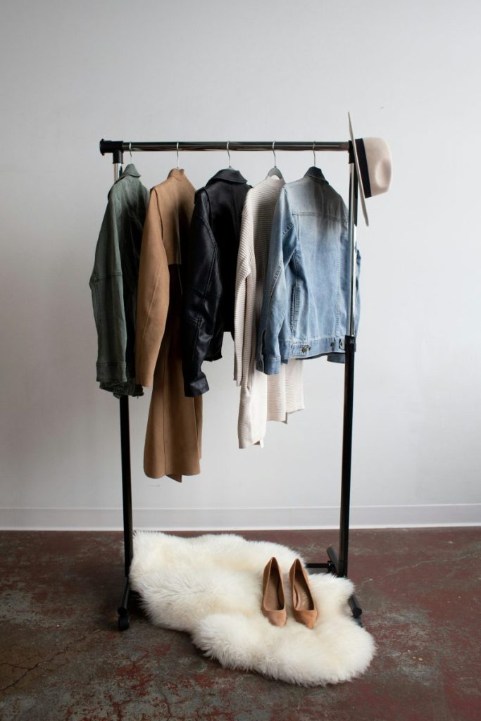 clothes on a clothing rack with white carpet