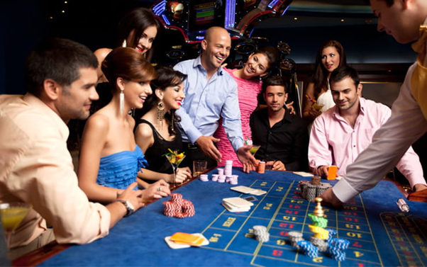 a group of people sitting around a casino table