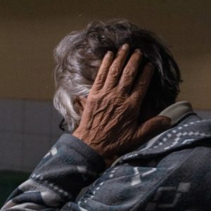 elderly man touching head