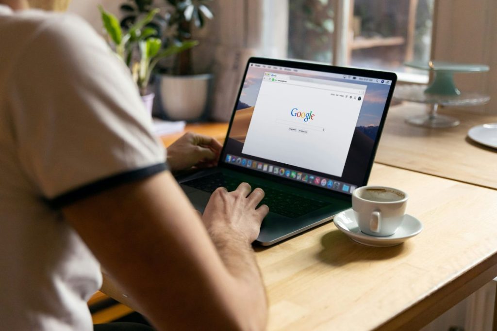 person looking at google on a laptop