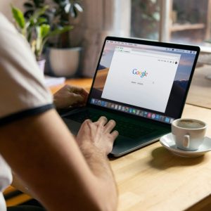 person looking at google on a laptop