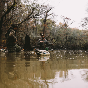 men and duck in water