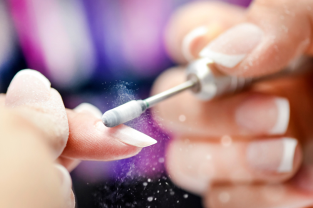 a person using a small tool to remove a nail