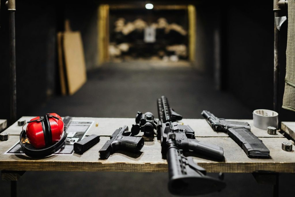 guns sitting on a table at shooting range