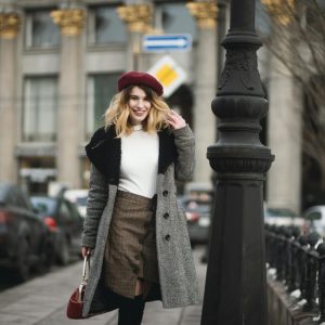 woman standing near post